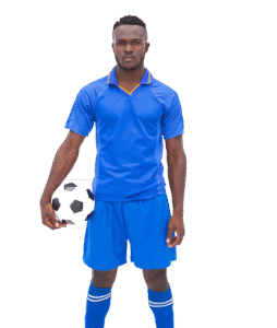 Jugador de fútbol con uniforme azul sosteniendo un balón de fútbol, posando frente a un fondo gris.